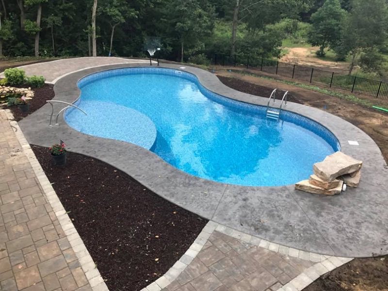 Free-form pool with new liner and stamped deck