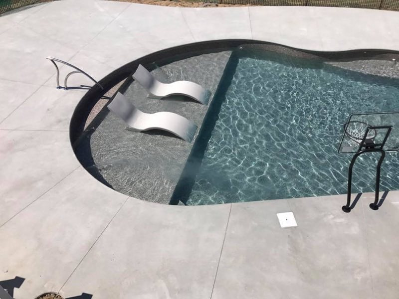 New sun ledge with loungers in a gunite pool